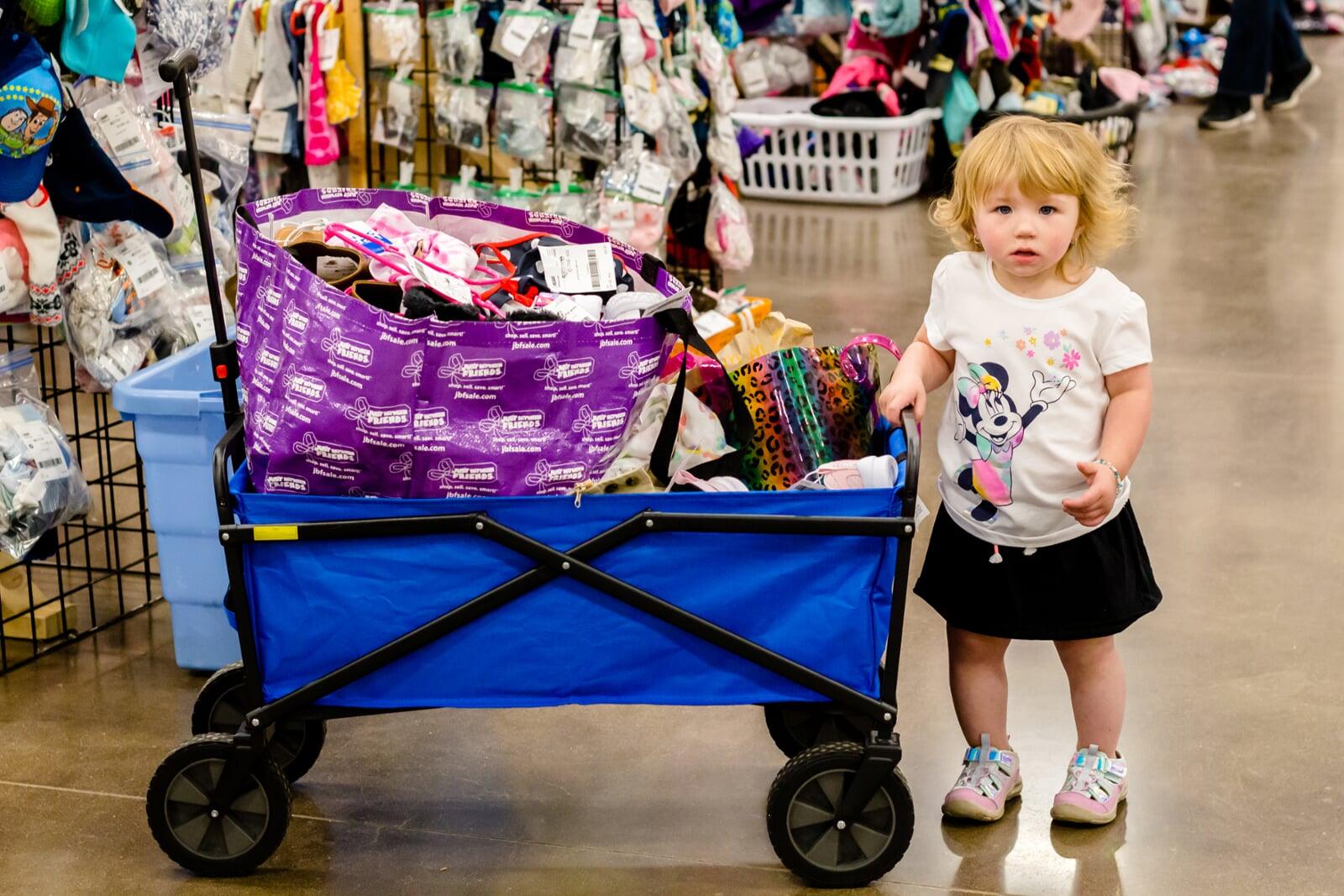 Toddler with wagon of merch AS22